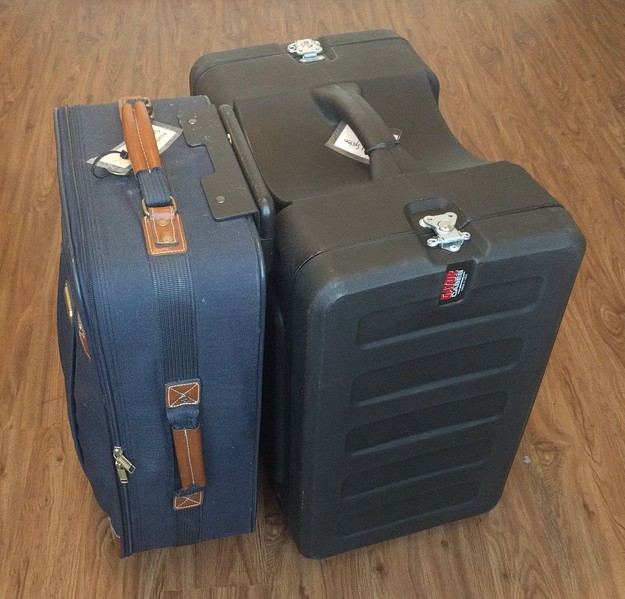 A suitcase and rack case, bundled for travel