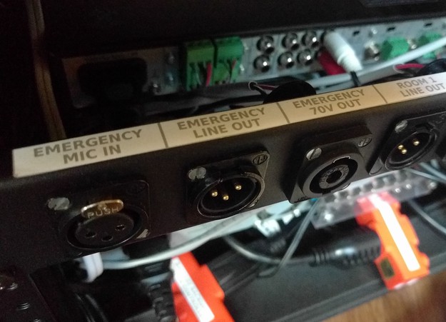 A close-up view of the three emergency connections, and their labels, on the rear patch panel